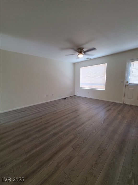 Spare room with dark wood-type flooring, a ceiling