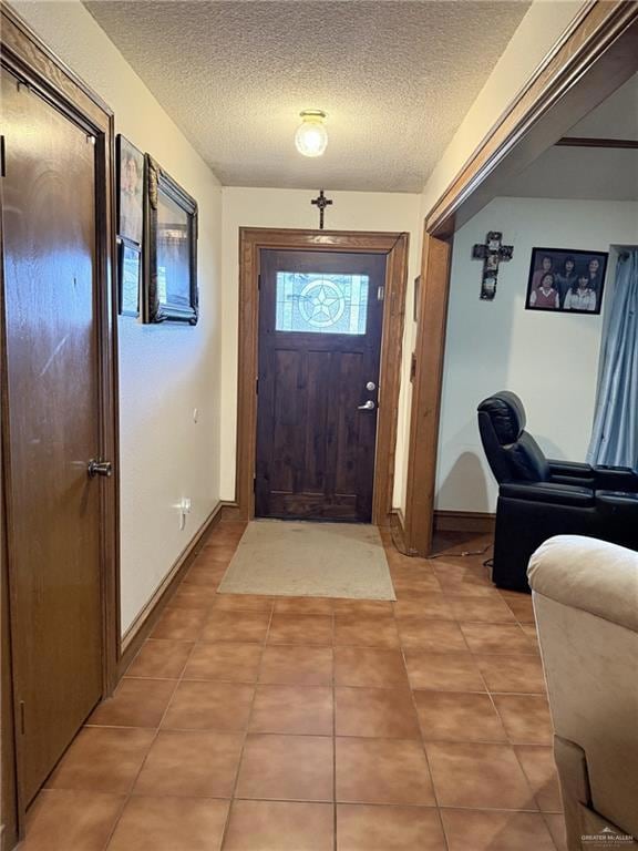 Foyer featuring a textured ceiling and light tile patterned floors