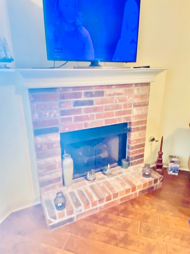 Detailed view of a fireplace and wood finished floors