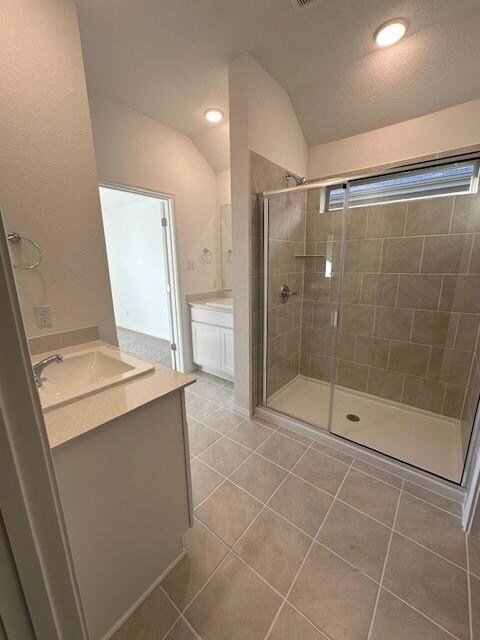 Full bathroom featuring vanity, a stall shower, t