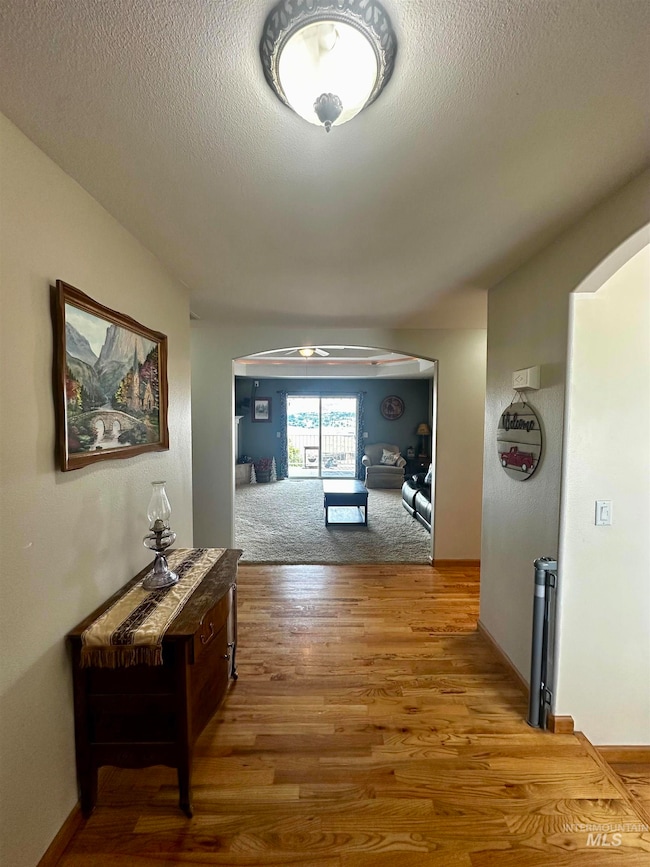 Entry/Foyer with hardwood finished floors and a textured ceiling