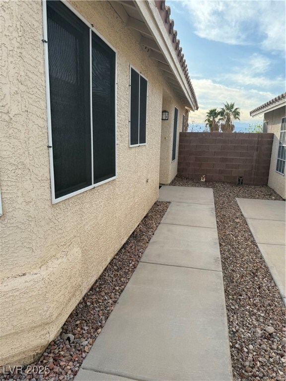View of property exterior featuring a tiled roof,