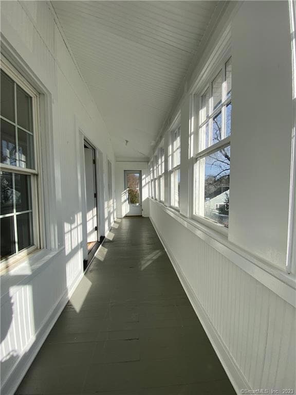The front porch runs the width of unit 1 with access to the street.