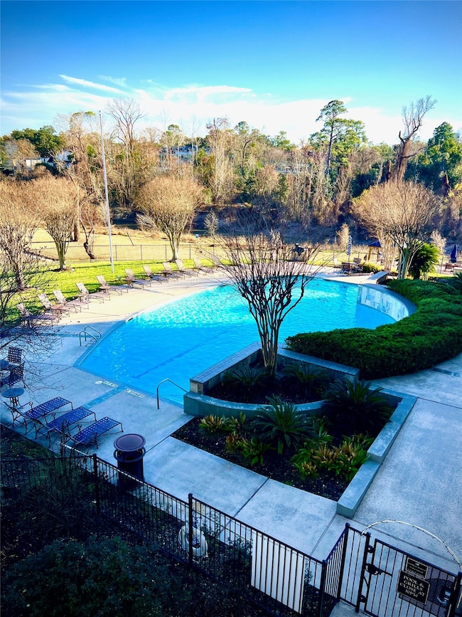 Large pool with lots of tranquil green space.