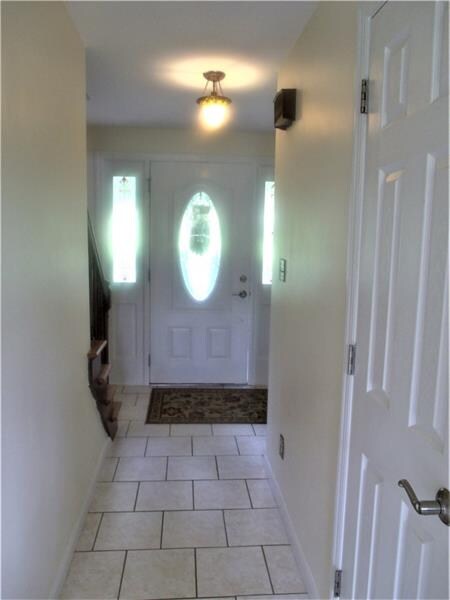 Ceramic tile flooring in the foyer that leads to t