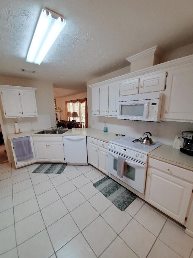 Kitchen with opening to Family