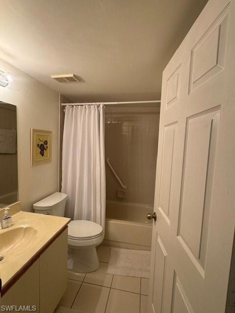 Full bathroom with tile patterned flooring, toilet