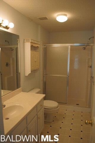 Light and bright - seat in shower. Vinyl flooring, built-in shelf over the commode.