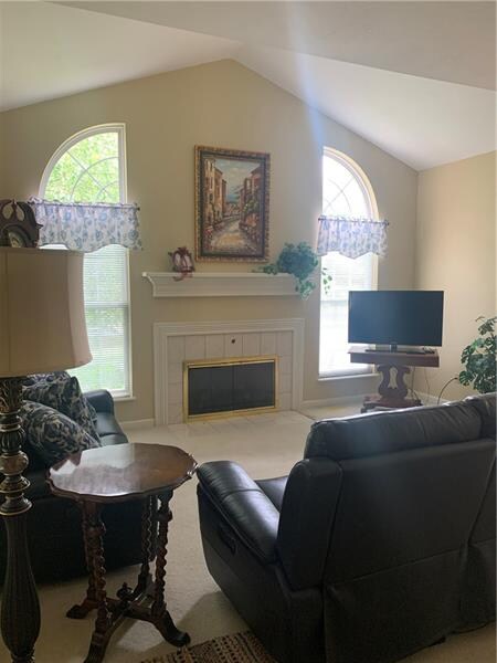 Living room with gas fireplace and beautiful windo