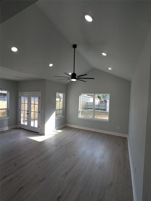 Empty room featuring french doors, ceiling fan, wo