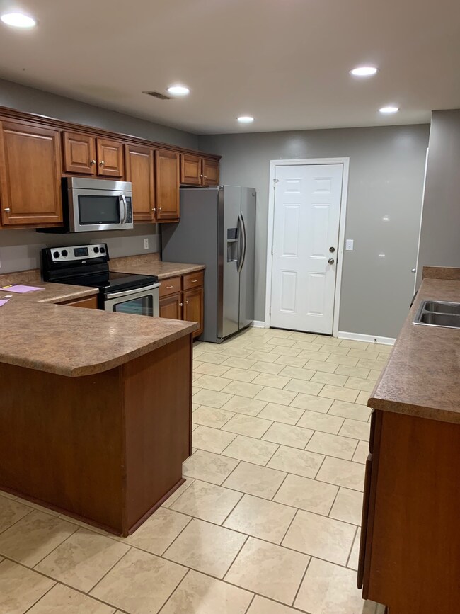 Large kitchen with many cabinets and a lot of work space. 