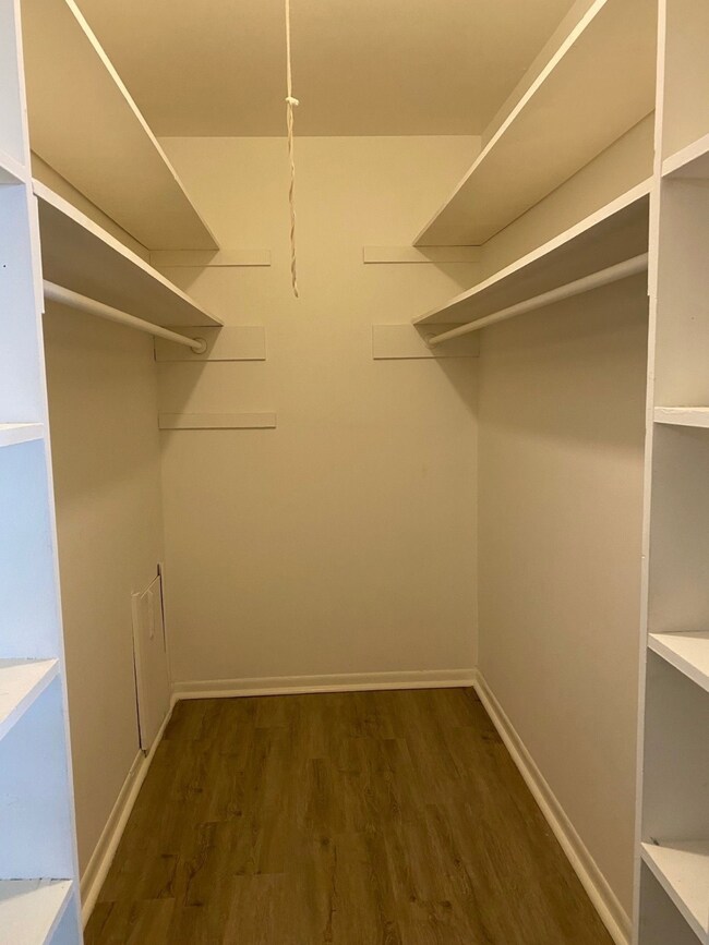 Spacious walk-in closet in primary bedroom with am