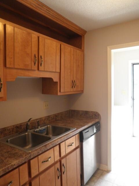 The kitchen leads to the laundry room and the door to the rear patio area and storage space. All appliances remain including the refrigerator, washer, and dryer.