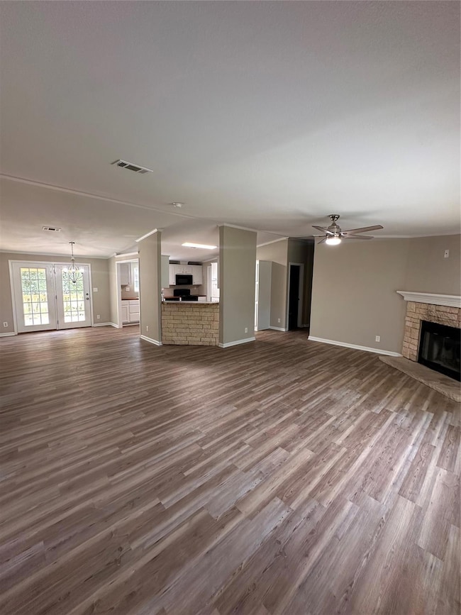Unfurnished living room featuring a fireplace, cei