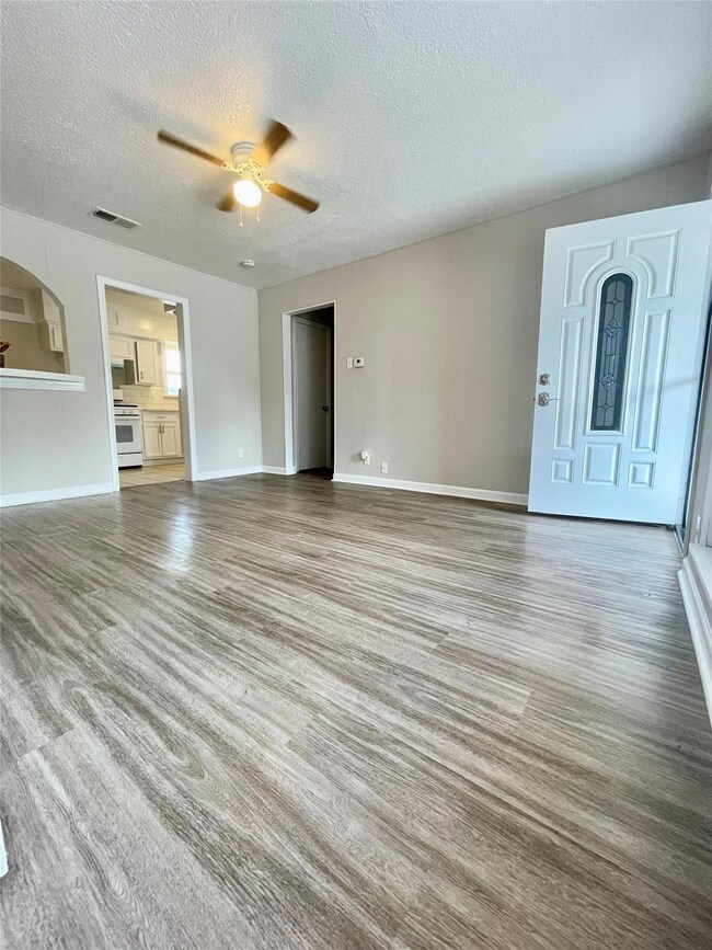 Unfurnished living room featuring hardwood / wood-
