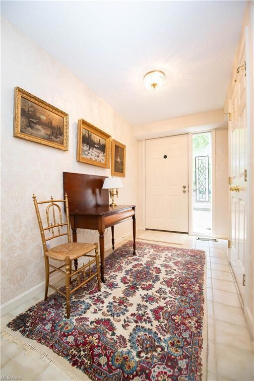 Sitting room featuring light tile floors