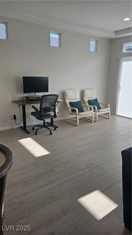 Office space featuring wood finished floors and re