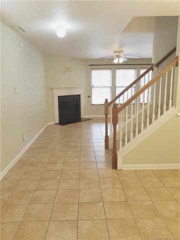 Ceramic tile downstairs with cornered fireplace