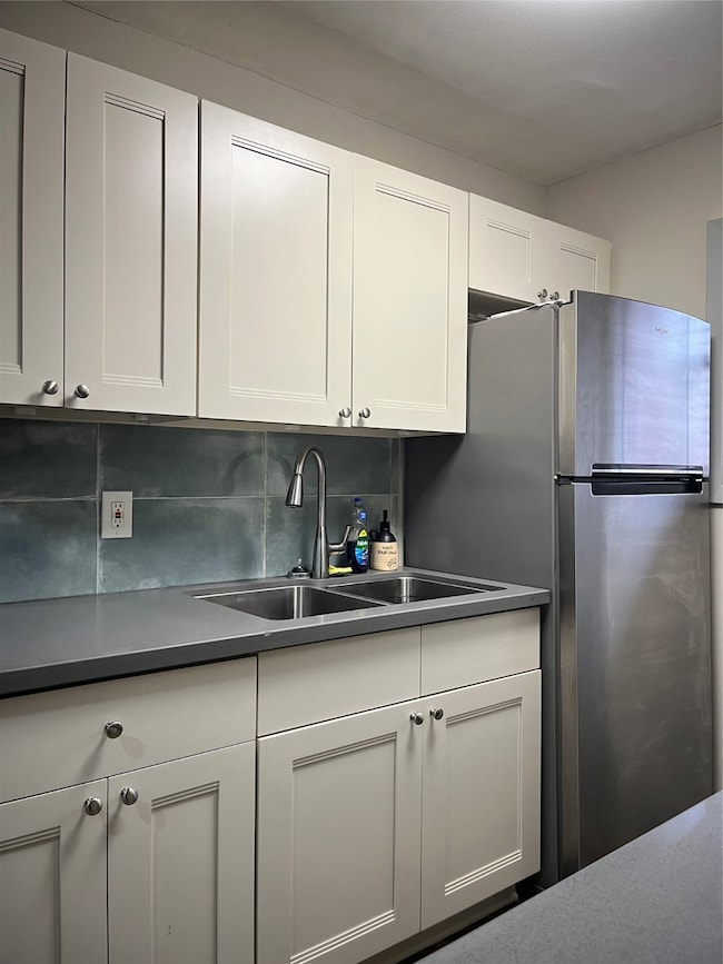 The kitchen features a gas stove/oven, microwave,