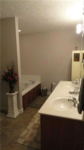 Master Bathroom with double sinks, whirlpool tub, separate linen closet and stand-up shower.