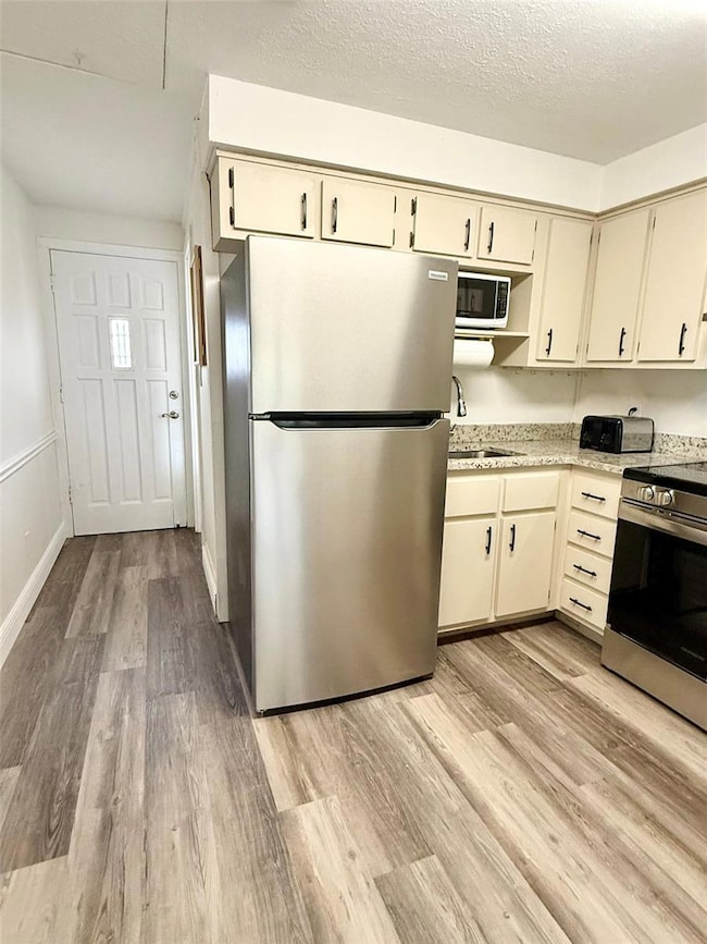 Kitchen features brand new stainless steel appliances,  granite countertops and breakfast bar