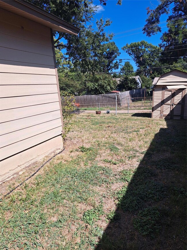 View of yard featuring a storage unit