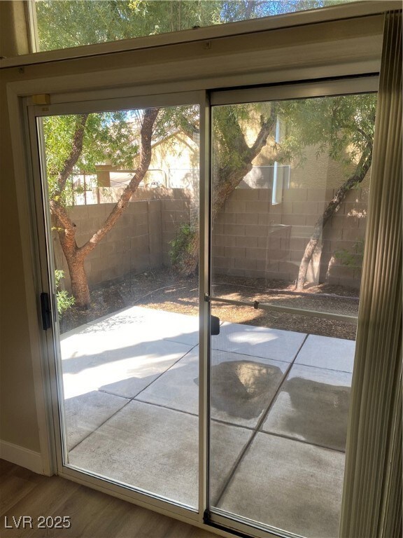 Doorway to outside featuring hardwood / wood-style