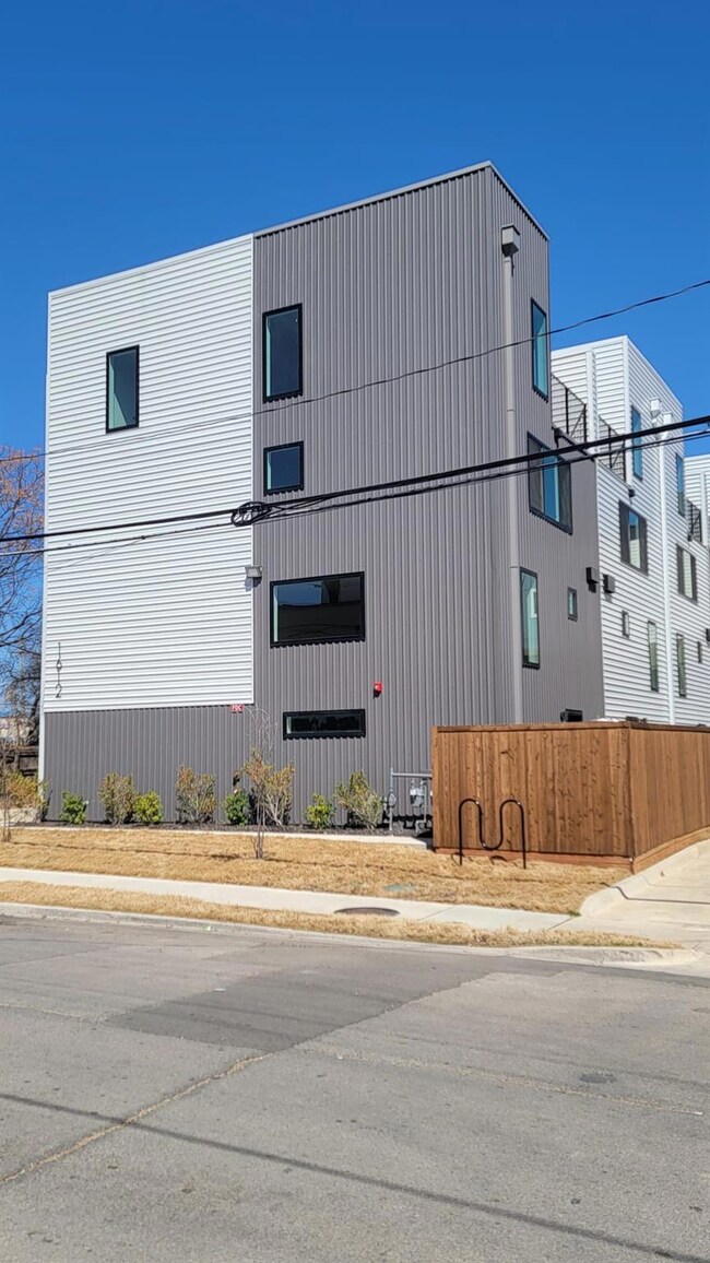 View of side of property featuring fence
