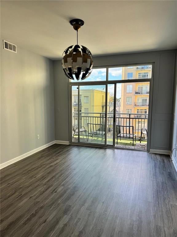 Unfurnished room featuring dark wood-type flooring
