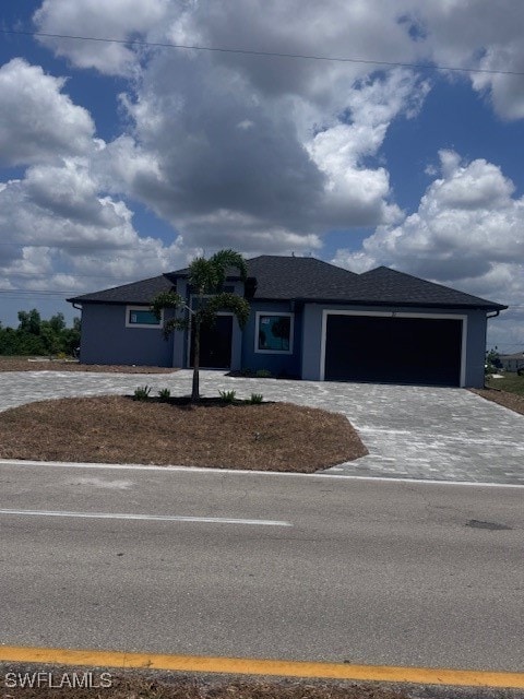 View of front of property with a garage and decora