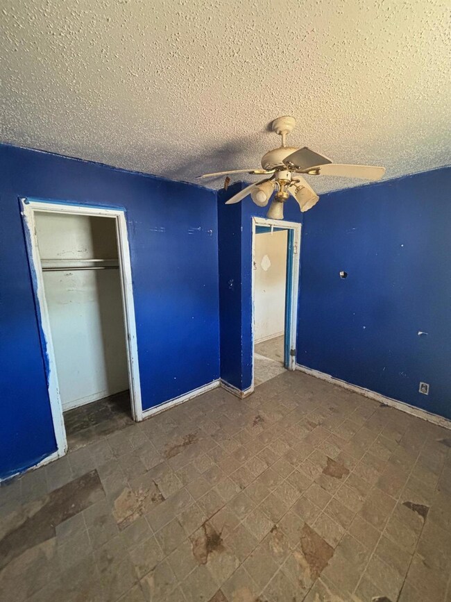 Unfurnished bedroom with tile patterned floors, a 