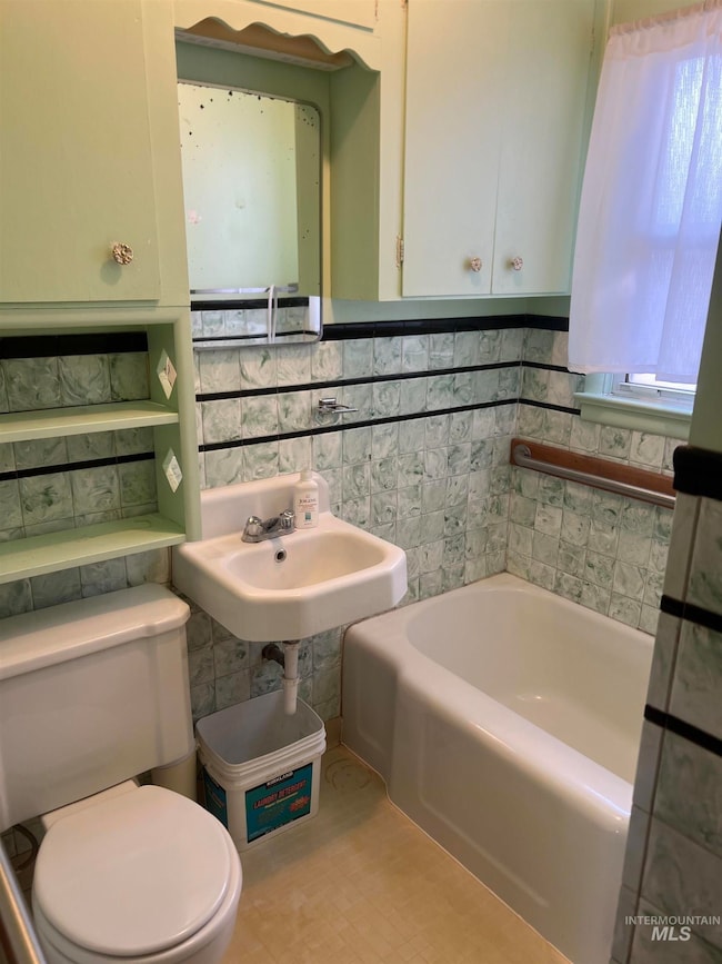 Bathroom with a tub to relax in and tile walls