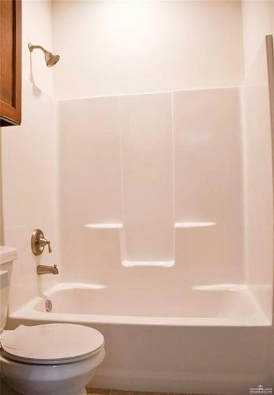 Bathroom featuring toilet and shower / bathing tub combination
