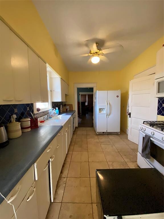 View of kitchen from laundry room looking into din
