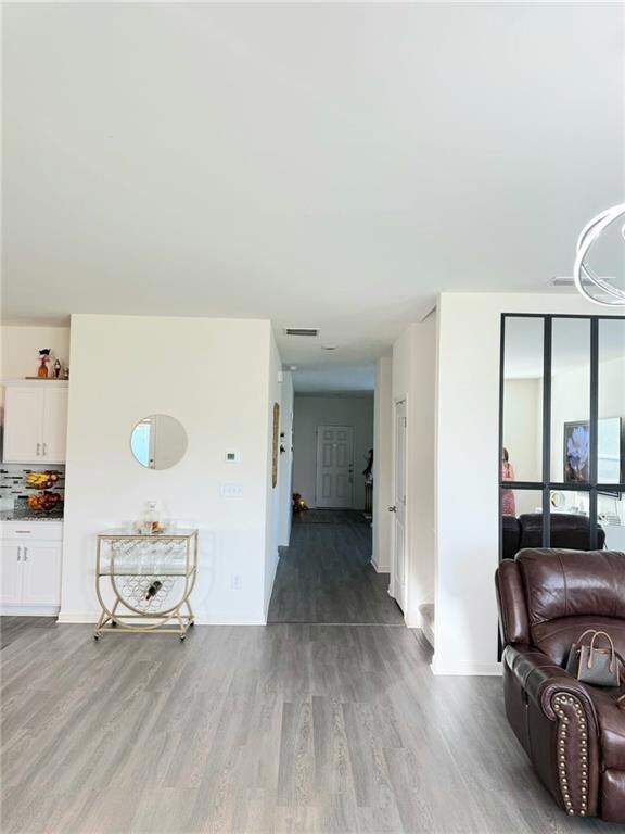 Corridor featuring wood finished floors and baseboards