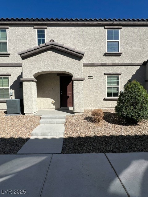 Property entrance featuring stucco siding
