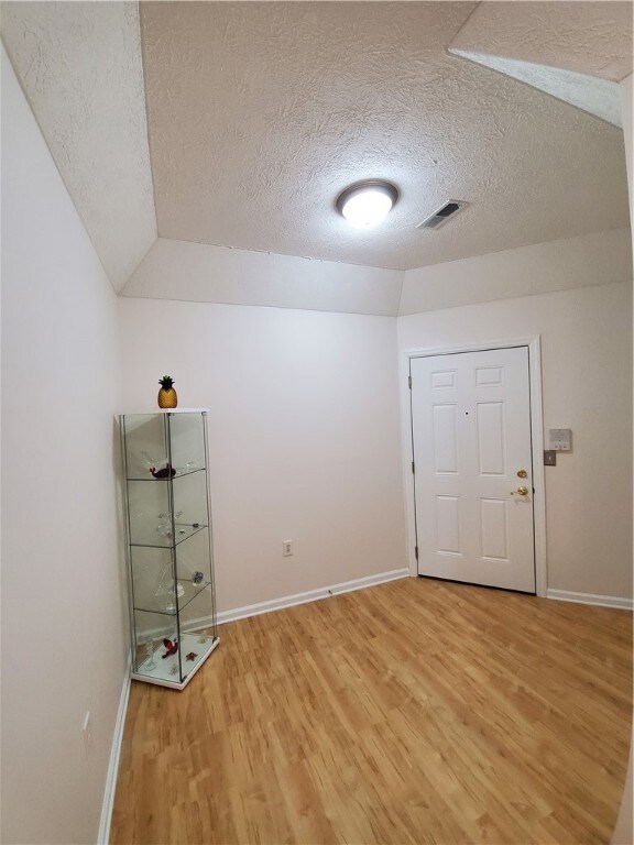 Entry area with tray ceiling and upgraded light fi