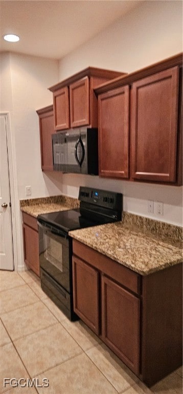 Kitchen with stove, light tile patterned flooring,