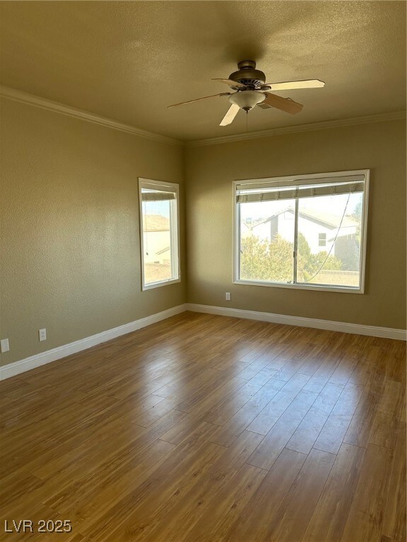 Unfurnished room with crown molding, a textured ce