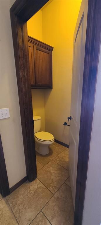 Bathroom with tile flooring and toilet
