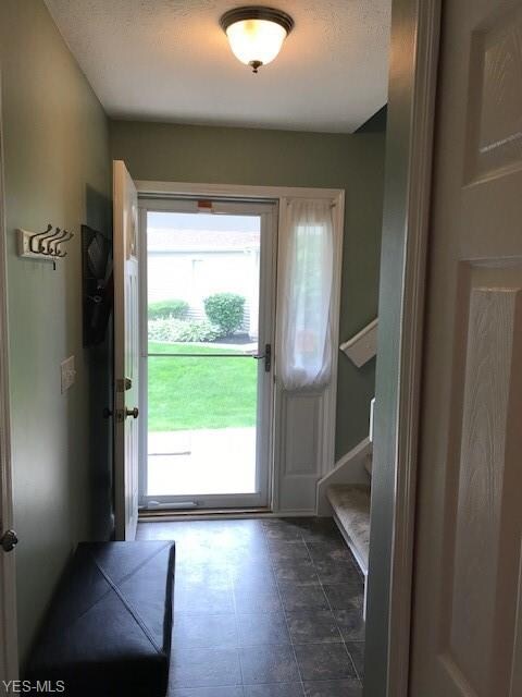 FOYER - LEADS TO UPPER AND MAIN FLRS - LAV BEHIND 