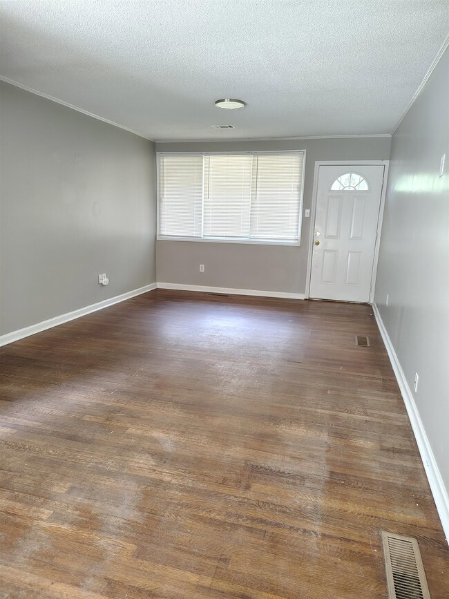 Entryway with a textured ceiling, ornamental moldi