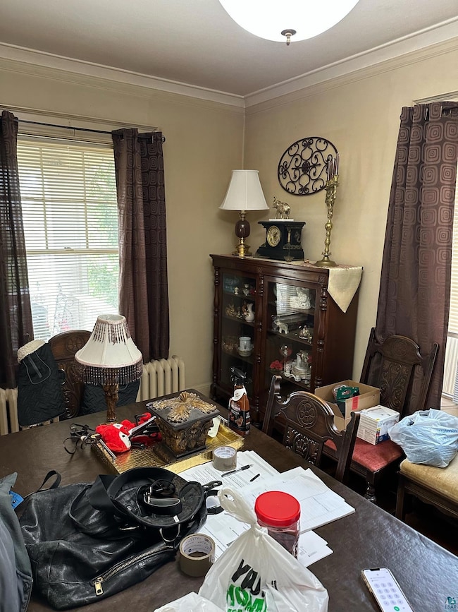 Dining room with crown molding and radiator