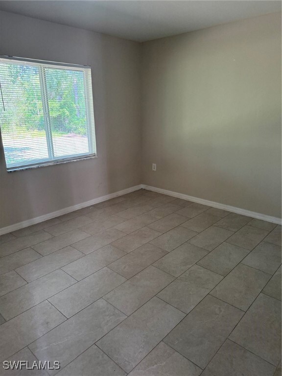 Unfurnished room featuring baseboards