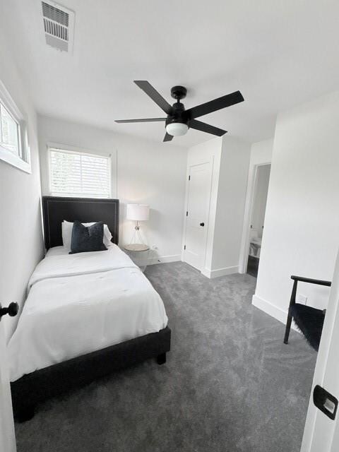 Carpeted bedroom featuring baseboards, a ceiling f