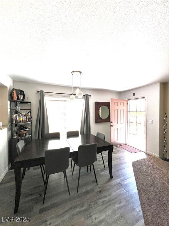 Dining room featuring a textured ceiling and wood