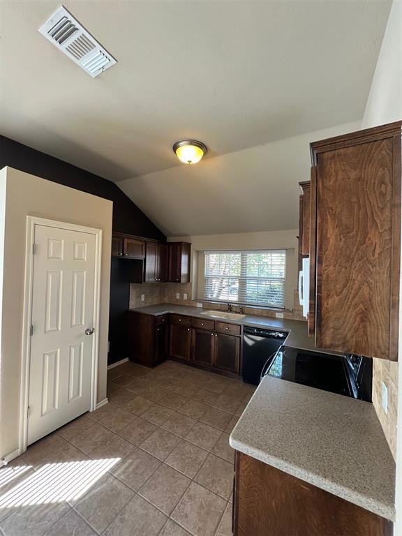 Kitchen featuring dark brown cabinets, dishwashing