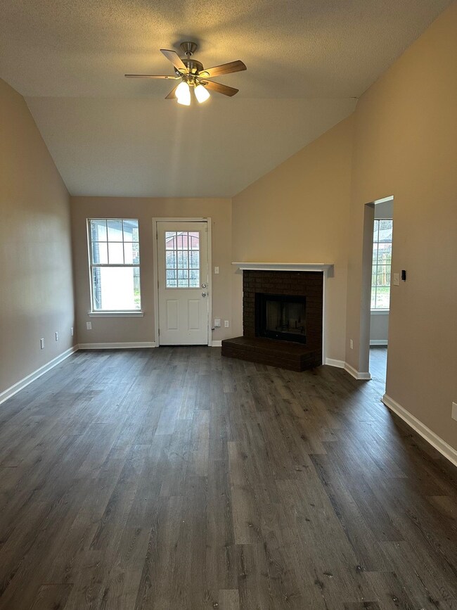 Unfurnished living room with a wealth of natural l