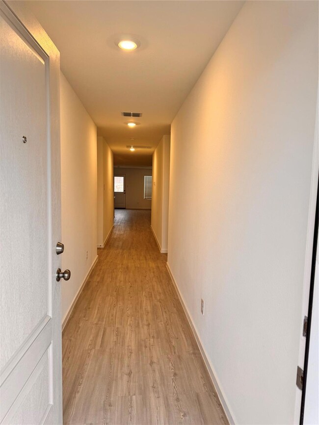 Hall featuring light wood-type flooring