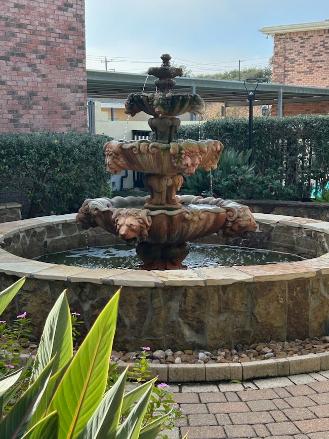 Right outside the front door is the three tiered fountain. Front entry gate to the courtyard is right behind the fountain under the carport.